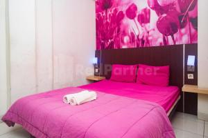 Letto o letti in una camera di Bies Malioboro Hotel RedPartner