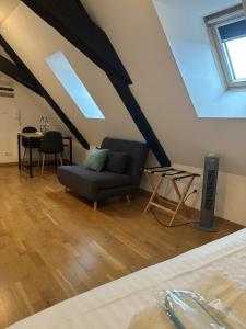 a living room with a couch and a table at L'écume des jours in Colmar