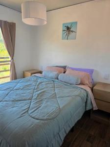 a bedroom with a bed with a blue comforter at MaryJor in La Pedrera
