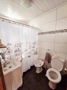 a bathroom with a toilet and a sink with a shower curtain at MaryJor in La Pedrera +22 photos