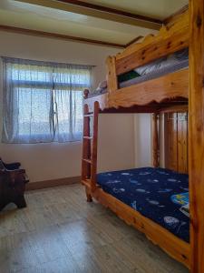 una camera con due letti a castello e due finestre di Sea of clouds view inn a Sagada