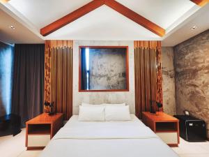 Voodi või voodid majutusasutuse Ipoh Santorini Hideaway - Hotel Inspired toas