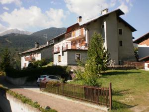 a house with a car parked in front of it at Apartment Da Renza in Bormio