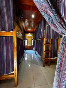 a corridor of a room with blue curtains at La Casa Nostra in Luang Prabang