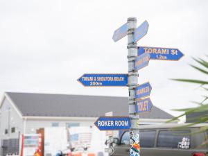a street sign with many street signs on a pole at Tabist Pension Third Place in Ichinomiya +92 photos