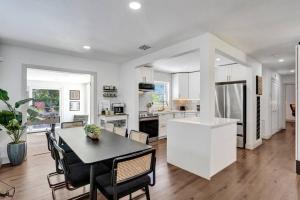 a kitchen and living room with a table and chairs at Palmpano Oasis, Heaven on Earth! Heated Pool! in Pompano Beach