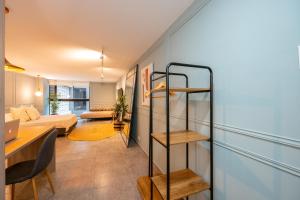 a living room with a staircase and a room with a couch at condo 305 in Medellín