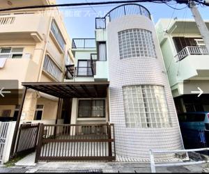 un edificio con una valla delante en Umikaji Base WAKASA, en Naha