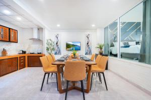 a kitchen and dining room with a table and chairs at Cozystay Center of Patong near Bangla Road in Patong Beach