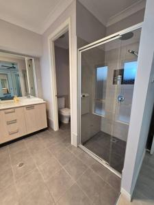 a bathroom with a shower and a sink and a toilet at Brand New Single story 5 bedroom house in Marsden Park in Marsden Park +11 photos
