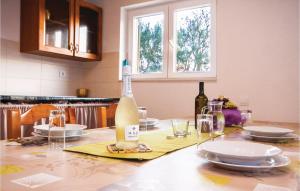 a dining room table with a bottle of wine on it at Holiday Home Jezera With A Fireplace 04 in Jezera