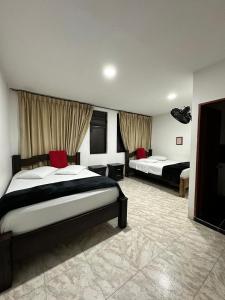 Postel nebo postele na pokoji v ubytování Hotel Plaza Real Pereira