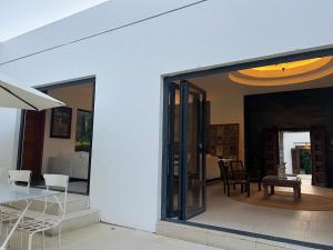 a dining room and kitchen with sliding glass doors at Blue Palm Villa with Private Pool & Tropical Garden in Cap Malheureux +40 photos