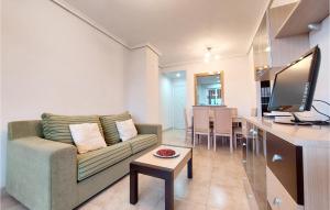 a living room with a couch and a table at Cozy Apartment In Oropesa Del Mar in Oropesa del Mar