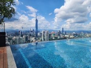 a swimming pool with a view of a city at Riveria City KL Sentral in Kuala Lumpur