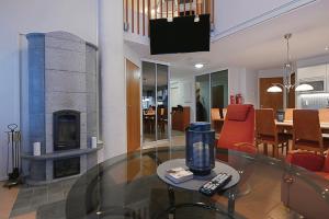a living room with a fireplace and a table with a tv at Central Alley 3B - including linen and towels in Levi