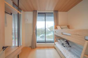 Ένα ή περισσότερα κρεβάτια σε δωμάτιο στο Queens Park CK Village Niseko Hirafu +62 φωτογραφίες