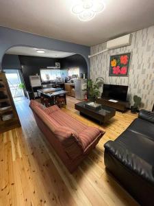 a living room with a couch and a fireplace at OUR HOUSE-Mie in Nishiki