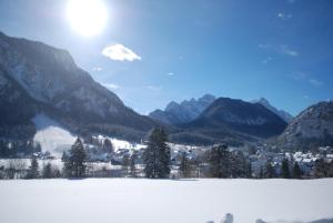 a snow covered valley with a town and mountains at Apartments Trata in Kranjska Gora