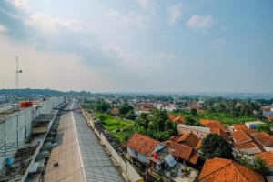 a view of a city from the roof of a building at Homey Studio at Bogorienze Apartment near The Jungle Waterpark By Travelio in Pamoyanan