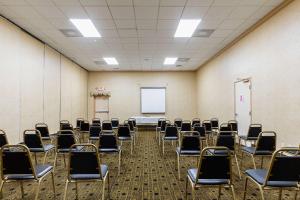 an empty room with chairs and a white screen at Quality Inn & Suites Coldwater near I-69 in Coldwater