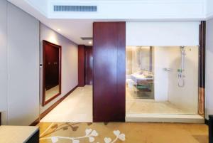 a bathroom with a shower and a glass door at Wyndham Garden Changzhou Zhonglou in Changzhou