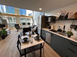 a kitchen with a table with dishes on it at New York Style Loft in Downtown Vancouver in Vancouver