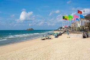 a beach with chairs and umbrellas and the ocean at Hải Long Hotel 2 in Vung Tau