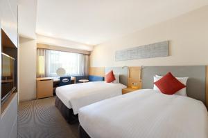 Postel nebo postele na pokoji v ubytování Hotel JAL City Kannai Yokohama