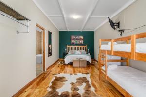 a bedroom with two bunk beds and a bathroom at Le Petit Karoo in Oudtshoorn +118 photos