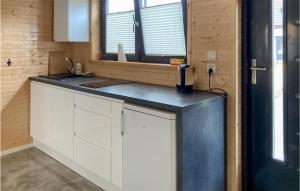 a kitchen with white cabinets and a counter top at Pet Friendly Home In Jantar With Sauna in Jantar