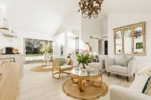 a living room with a table and chairs at Luna by Experience Jervis Bay in Huskisson