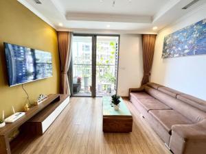 a living room with a couch and a table at BOM HOMES- Vinhomes Timescity-3Br-Luxury Apt in Hanoi