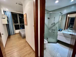 a bathroom with a shower and a toilet and a sink at BOM HOMES- Vinhomes Timescity-3Br-Luxury Apt in Hanoi