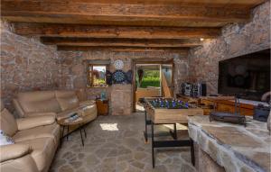 a living room with a couch and a table with a chessboard at Gorgeous Home In Polje With Wifi in Polje