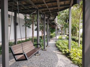 a wooden swing hanging from a building at Trion Residence Kuala Lumpur BY Sky Rainbow in Kuala Lumpur