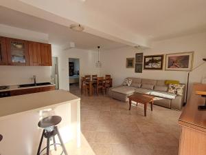 a living room and kitchen with a couch and a table at Apartment Complex Kampic in Poreč