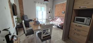 a living room with a table and a living room with a couch at Piero's Apartment in Carbonia