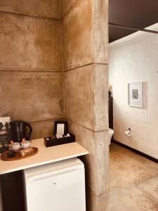 a kitchen with a counter and a refrigerator in a room at Cellar Pods Blue in Robertson