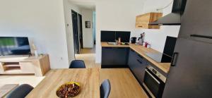 a kitchen with a wooden table and a plate of food at Gite Alsacien in Roggenhouse