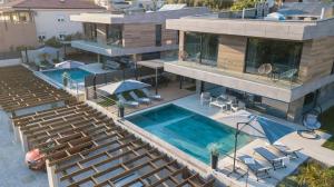 an aerial view of a house with a swimming pool at Luxury Villa Pearl 2 with infinity pool in Baška