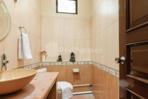 a bathroom with a bowl sink and a toilet at SR Residence near Mall Ciputra Cibubur Mitra RedDoorz in Bekasi +27 photos