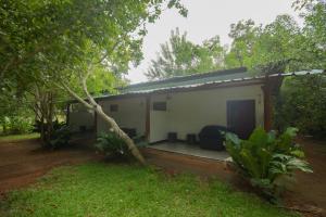 a small house in the middle of a forest at Lake Side Resort in Kekirawa