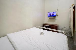 a hospital room with a bed and a tv at Redisa RedPartner near RS Saiful Anwar in Malang