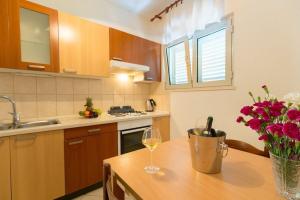 a kitchen with a table with a glass of wine at House Marija in Korčula