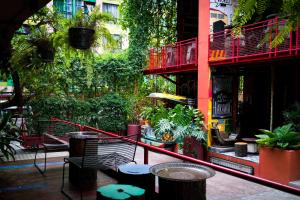 a patio with a bunch of plants on a building at MeStyle Museum Hotel in Bangkok