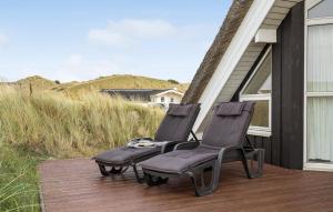 two chairs sitting on the porch of a house at Lyngbo in Havrvig +12 photos