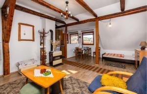 a living room with a table and a couch at Cozy Apartment In Ravna Gora With Wifi in Ravna Gora