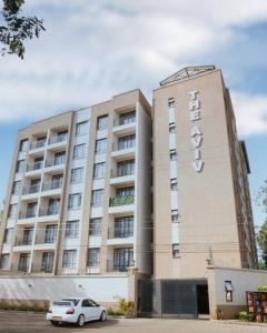 a building with a car parked in front of it at 1 bedroom cosy apartment in Nairobi, Kitsuru in Nairobi