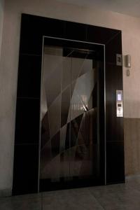 a glass door to a elevator in a building at 1 bedroom cosy apartment in Nairobi, Kitsuru in Nairobi +11 photos